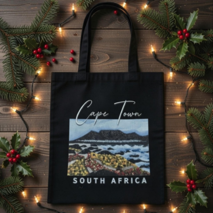 Black Graphic Tote Bag with a view of Table Mountain from Blaauwberg Beach with sand dunes and flora as well as the vastness of the Atlantic Ocean in Cape Town, South Africa - Tabletop Serenity by René Tesner - Product (Informative)