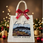 Beige Graphic Tote Bag with a view of Table Mountain fromBlaauwberg Beach with sand dunes and flora as well as the vastness of the Atlantic Ocean in Cape Town, South Africa - Tabletop Serenity by René Tesner - Product (Informative)